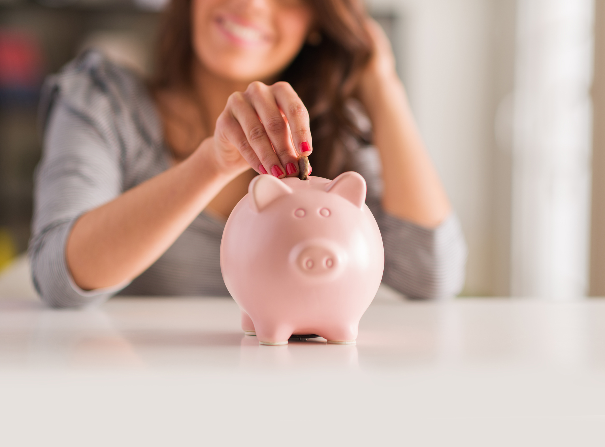 Savings-Products Piggy bank being used to save.